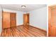 A bright bedroom featuring wood floors, closet, and a fresh paint, creating an inviting and comfortable space at 8308 W Main St, Coatesville, IN 46121