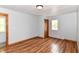 Bedroom showcasing wood flooring, natural light, and wood trim, creating an inviting living space at 8308 W Main St, Coatesville, IN 46121
