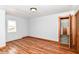 Cozy bedroom featuring a hardwood floor, window, and wood trim, creating a warm and inviting space at 8308 W Main St, Coatesville, IN 46121
