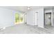 Carpeted bedroom with backyard deck access, neutral paint, and overhead lighting at 8308 W Main St, Coatesville, IN 46121