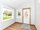 Inviting foyer with beautiful wood-look flooring and a decorative front door at 8308 W Main St, Coatesville, IN 46121
