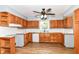 Spacious kitchen boasts wood cabinets, a modern ceiling fan, and natural light at 8308 W Main St, Coatesville, IN 46121