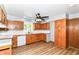 Bright kitchen featuring wood cabinets, white backsplash, and sleek countertops at 8308 W Main St, Coatesville, IN 46121