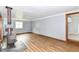 Inviting living room featuring wood flooring and a cozy wood-burning stove at 8308 W Main St, Coatesville, IN 46121