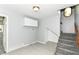 Mud room area with stairs, gray tiling, overhead lighting, and storage space at 8308 W Main St, Coatesville, IN 46121