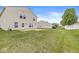 Large, green backyard featuring a well-maintained lawn and privacy fence, ideal for outdoor activities and relaxation at 8910 Youngs Creek Ln, Indianapolis, IN 46113