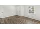 Bedroom featuring gray wood floors, neutral walls, a closet, and a window at 8910 Youngs Creek Ln, Indianapolis, IN 46113