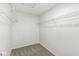 Spacious walk-in closet offering wire shelving and neutral carpeting for organized storage at 8910 Youngs Creek Ln, Indianapolis, IN 46113
