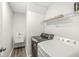 Laundry room equipped with modern washer and dryer units, and a utility sink at 8910 Youngs Creek Ln, Indianapolis, IN 46113