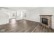 Open-concept living room with wood floors and a brick fireplace at 8910 Youngs Creek Ln, Indianapolis, IN 46113