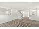 Spacious living room featuring gray wood floors, neutral walls, an open staircase and connecting rooms at 8910 Youngs Creek Ln, Indianapolis, IN 46113