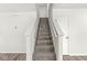 Carpeted staircase leading to the upper level with white walls and white railing at 8910 Youngs Creek Ln, Indianapolis, IN 46113