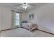 Bedroom featuring neutral carpet and walls, ceiling fan, window and twin size bed with floral coverlet at 912 Ramblin Rd, Greenwood, IN 46142