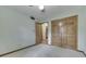 Neutral bedroom with a ceiling fan, closet with natural wood doors, and doorway leading to other rooms at 912 Ramblin Rd, Greenwood, IN 46142