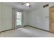 Neutral carpeted bedroom with window, natural wood door, ceiling fan and neutral walls at 912 Ramblin Rd, Greenwood, IN 46142