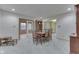 Light-filled dining room with view to second dining area, complete with table and seating for six at 912 Ramblin Rd, Greenwood, IN 46142