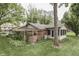 Expansive backyard with well-kept lawn and charming features like trellis and sunroom at 912 Ramblin Rd, Greenwood, IN 46142