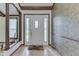 Bright foyer features hardwood floors, decorative front door, and a view to the living room at 912 Ramblin Rd, Greenwood, IN 46142