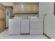 Functional laundry area with side-by-side washer and dryer and plenty of cabinet space at 912 Ramblin Rd, Greenwood, IN 46142