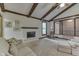 Comfortable living room with a white brick fireplace, exposed beams, and a large window at 912 Ramblin Rd, Greenwood, IN 46142