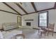 Spacious living room featuring a brick fireplace, neutral carpet, exposed beams, and comfortable seating at 912 Ramblin Rd, Greenwood, IN 46142