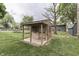 Charming shed with a covered porch surrounded by green grass and mature trees at 912 Ramblin Rd, Greenwood, IN 46142