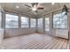 Sunroom featuring wood floor, brick walls, ceiling fan and multiple windows at 912 Ramblin Rd, Greenwood, IN 46142