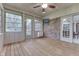 Sunroom with wood floor, ceiling fan, brick walls, multiple windows and white trim at 912 Ramblin Rd, Greenwood, IN 46142
