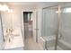 Bright bathroom featuring double sinks, tile flooring, and glass-enclosed shower, with an open view into the bedroom at 9176 Springbrook Dr, Pendleton, IN 46064