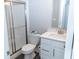 Bathroom showcasing a glass door shower, toilet and vanity with a modern sink, perfect for a guest at 9176 Springbrook Dr, Pendleton, IN 46064