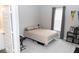 Neutral bedroom with a bed, window, gray curtains and a bookshelf displaying books and a Baylor Bears banner at 9176 Springbrook Dr, Pendleton, IN 46064