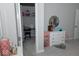 Bedroom view into a closet featuring a desk, dresser, and a decorative round mirror at 9176 Springbrook Dr, Pendleton, IN 46064