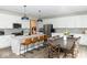 Spacious kitchen featuring white cabinets, a large island with seating, and a dining area at 9176 Springbrook Dr, Pendleton, IN 46064