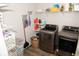 This laundry room features wood floors, modern appliances, and ample shelving at 9176 Springbrook Dr, Pendleton, IN 46064