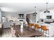 Open concept living room and kitchen with hardwood floors and staircase to upper level at 9176 Springbrook Dr, Pendleton, IN 46064