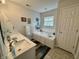 Bright bathroom with double sinks, bathtub and tile flooring at 9653 Woodsong Way, Indianapolis, IN 46229