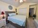 Bright bedroom featuring a large bed with soft blue bedding, and a calming decorative wall art piece at 9653 Woodsong Way, Indianapolis, IN 46229