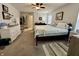 Comfortable bedroom with carpeted floors, ceiling fan, and ensuite at 9653 Woodsong Way, Indianapolis, IN 46229
