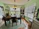 Charming dining room with wooden table, matching chairs, decorative chandelier, and window views at 9653 Woodsong Way, Indianapolis, IN 46229