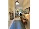 Hallway with tile flooring, leading to a living room with hardwood floors and a fireplace at 9653 Woodsong Way, Indianapolis, IN 46229