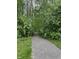 Well-maintained walking trail through lush woods; 'Woodsong Nature Trail' sign visible at 9653 Woodsong Way, Indianapolis, IN 46229