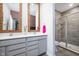 Modern bathroom with dual sinks, a glass shower, and updated fixtures at 9804 Canyon Ln, Pendleton, IN 46064