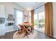 Cozy breakfast nook with rustic wooden table, comfortable seating, and natural light, ideal for casual meals and gatherings at 9804 Canyon Ln, Pendleton, IN 46064