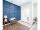 Elegant entryway with modern blue accent wall, decorative furnishings, and a bright, welcoming ambiance at 9804 Canyon Ln, Pendleton, IN 46064