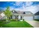 Beautiful brick home with a well-manicured lawn and charming front porch, offering great curb appeal at 9804 Canyon Ln, Pendleton, IN 46064