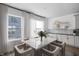 Bright dining area adjacent to the kitchen, featuring large windows, a modern table, and stylish chairs at 9891 Baneberry Ln, Carmel, IN 46290
