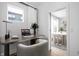 Bright home office featuring a modern desk, chair, and view into dining area at 9891 Baneberry Ln, Carmel, IN 46290