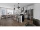 Modern kitchen features a large island, gray countertops, stainless steel appliances and open layout to dining area at 9891 Baneberry Ln, Carmel, IN 46290