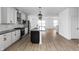 Spacious kitchen with gray countertops, white cabinets, stainless steel appliances, and an open layout at 9891 Baneberry Ln, Carmel, IN 46290
