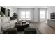 Modern living room with a stylish sofa, contemporary decor, large windows, and comfortable seating area at 9891 Baneberry Ln, Carmel, IN 46290
